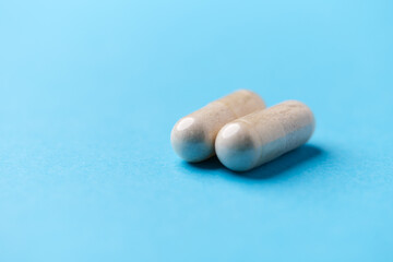 Amino acids capsules on bright background. Soft focus. Close up. Copy space.	
