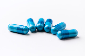 Amino acids capsules on bright background. Soft focus. Close up. Copy space.