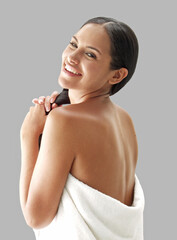 Latin woman spa wearing bath towel after shower isolated on neutral background.
