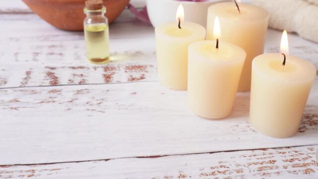 Travel to elements of a spa with candles, flower petals, and oil