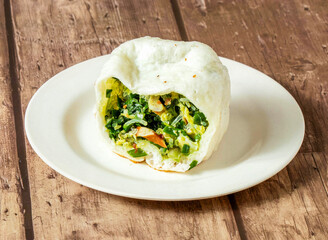Steamed Bun with Fresh Chive and Egg Filling on a White Plate side view of taiwan food