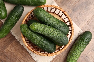 Fresh cucumbers on wooden table, flat lay