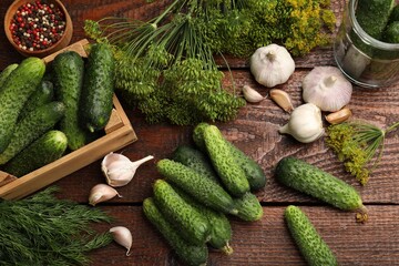 Making pickles. Fresh cucumbers and spices on wooden table, flat lay