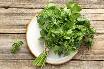 Bunch of fresh parsley on wooden table, top view