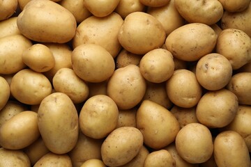 Fresh raw potatoes as background, top view