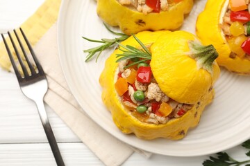 Tasty stuffed pattypan squashes served on white wooden table, flat lay