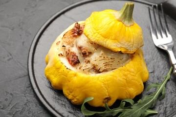 Tasty stuffed pattypan squash served on black table, closeup