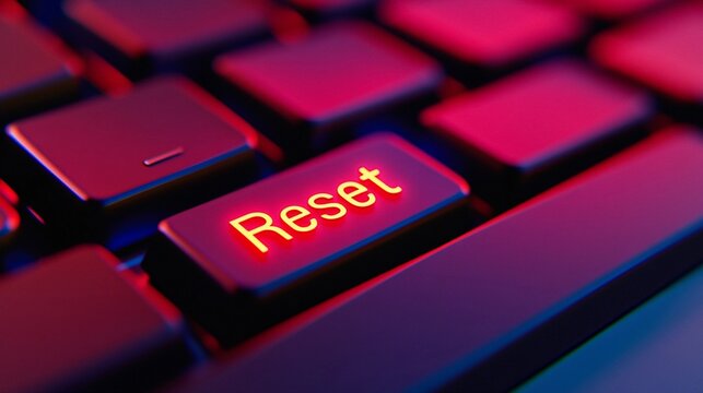 Close-up view of a glowing reset key on a computer keyboard illuminated by colorful lights - Powered by Adobe