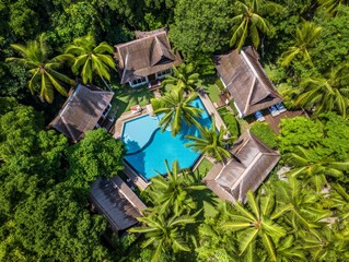 Aerial View of Luxury Bungalows with Pool Surrounded by Palm Trees in Tropical Setting