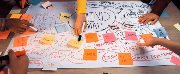 A group of diverse individuals engaged in a dynamic brainstorming session, creating a vibrant mind...