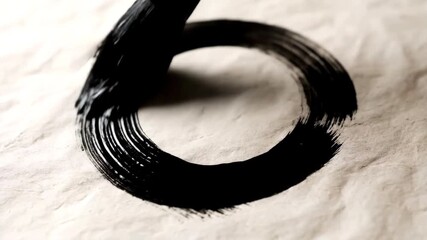Extreme close-up of a calligraphy brush painting a black ink enso circle on textured paper in a single stroke - Powered by Adobe