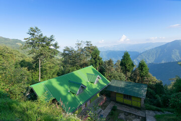 Okhrey village, Himalayan mountain range in the background . Okhrey is a remote village with breath taking scenic natural vista of world famous Himalayan Mountains in image, in Sikkim, India.