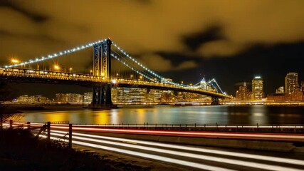 Dynamic Manhattan Bridge at Night with Light Trails, capturing vibrant city movement, perfect for travel vlogs, urban documentaries, or establishing shots of New York's iconic skyline