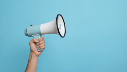 Hand holds megaphone on blue background. Person shouts loud message. Communication, leadership, announcement concept. Businesswoman businessman use for public speaking, presentation, marketing.