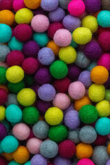 Colorful felt wool balls background, full frame