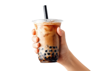Hand holding bubble tea with tapioca pearls against a black background, close up
