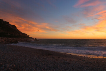 sunset over the sea sky on fire with many orange colors 