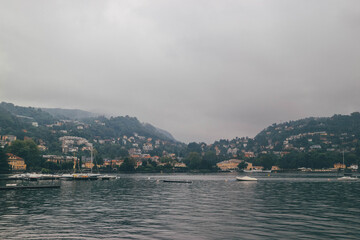 Fototapeta premium lake in the mountains como italy moody autumn foggy look with swans swimming
