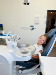  A little girl in a dental office for a dental checkup and treatment  