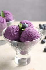 Tasty sorbet with blueberries and mint on light grey table, closeup