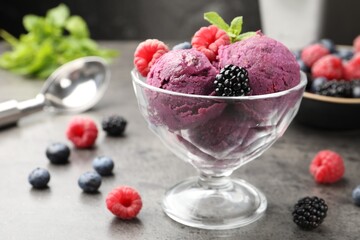 Delicious sorbet with fresh berries and mint in dessert bowl on grey textured table, closeup