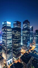 Obraz premium Aerial view of illuminated city skyscrapers at night