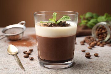 Delicious coffee panna cotta, beans and mint on grey table, closeup