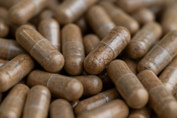 Close up of Light Brown Capsules Filled with Natural Supplement Powder