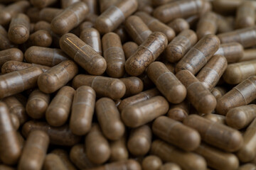 Close up of Light Brown Capsules Filled with Natural Supplement Powder