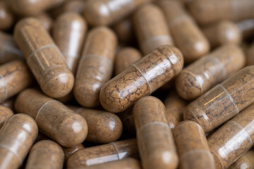 Close up of Light Brown Capsules Filled with Natural Supplement Powder