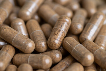 Close up of Light Brown Capsules Filled with Natural Supplement Powder