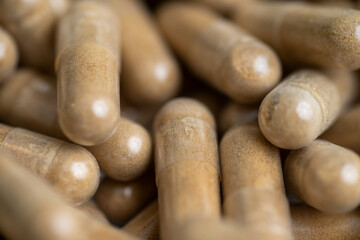 Close up of Light Brown Capsules Filled with Natural Supplement Powder
