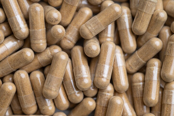 Close up of Light Brown Capsules Filled with Natural Supplement Powder