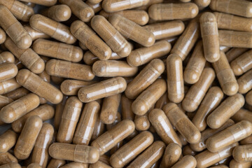 Close up of Light Brown Capsules Filled with Natural Supplement Powder