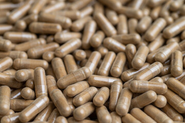 Close up of Light Brown Capsules Filled with Natural Supplement Powder