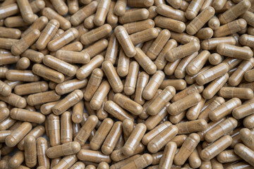 Close up of Light Brown Capsules Filled with Natural Supplement Powder