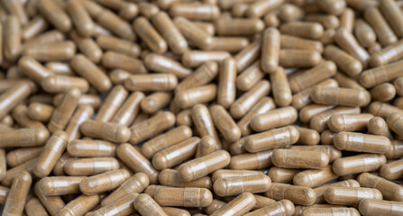 Close up of Light Brown Capsules Filled with Natural Supplement Powder