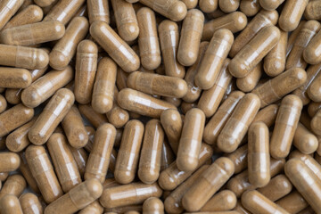 Close up of Light Brown Capsules Filled with Natural Supplement Powder