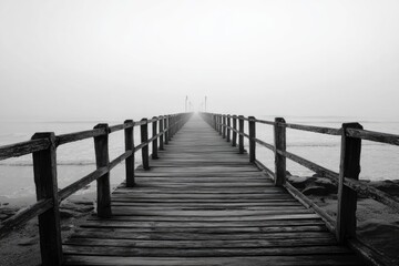 Misty wooden pier stretching into hazy distance
