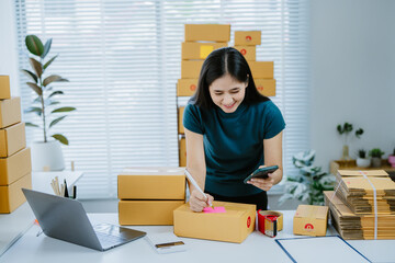 SME owners, Asian woman check online orders Selling products working with boxs freelance work at home office, sme business online small medium enterprise.