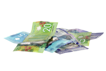 Messy pile of Canadian dollar bills in mixed denominations isolated cutout on transparent
