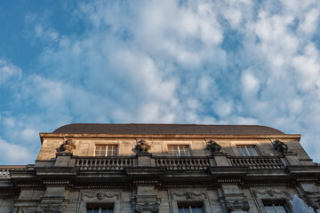 The ornate Baroque facade of a historic European palace in warm sunlight.