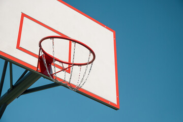 Basketball backboard hoop on sports court against clear blue sky. Outdoors. Summer game. Copy space. Mock up. © svetlana_cherruty