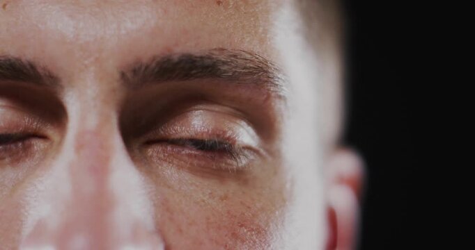 Mid adult man holding gaze activating lightning overlay pulsing across brow and cheek in tech demo