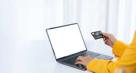 Online Shopping: A person with a sleek laptop and a credit card, engaging in seamless online shopping. This image captures the convenience and modernity of digital commerce.