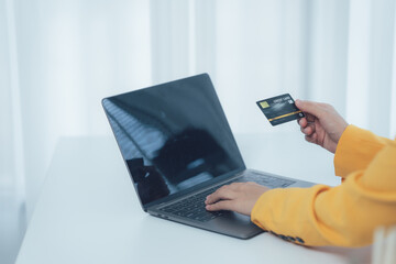 Online Shopping: A person is engrossed in the seamless process of online shopping, poised to finalize a transaction using a credit card on a sleek laptop, ready to explore a vast digital marketplace.