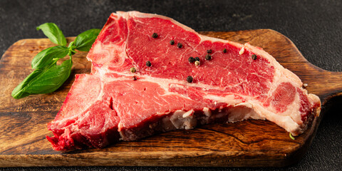 Raw steak T-bone fresh meat premium beef snack fresh delicious gourmet food background on the table rustic food top view copy space