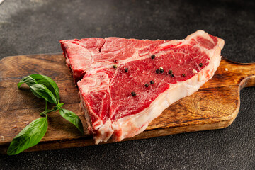 Raw steak T-bone fresh meat premium beef snack fresh delicious gourmet food background on the table rustic food top view copy space