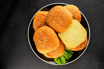Bun burger puffy soft buns baking fresh delicious gourmet food background on the table rustic food top view copy space