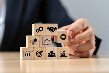 Business strategy and planning concept, wooden blocks with icons of business goals